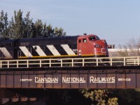 I never tired of shooting VIA's passenger trains in downtown Winnipeg, especially when they were graced by CN's classy F7Au locomotives. Here we have the 9151 and an unrecorded sister (with an SGU) pausing on the bridge over the Assiniboine River before backing into the station to couple to their train. For a more recent view of the same location, see image 48728 (http://www.railpictures.ca/?attachment_id=48728).