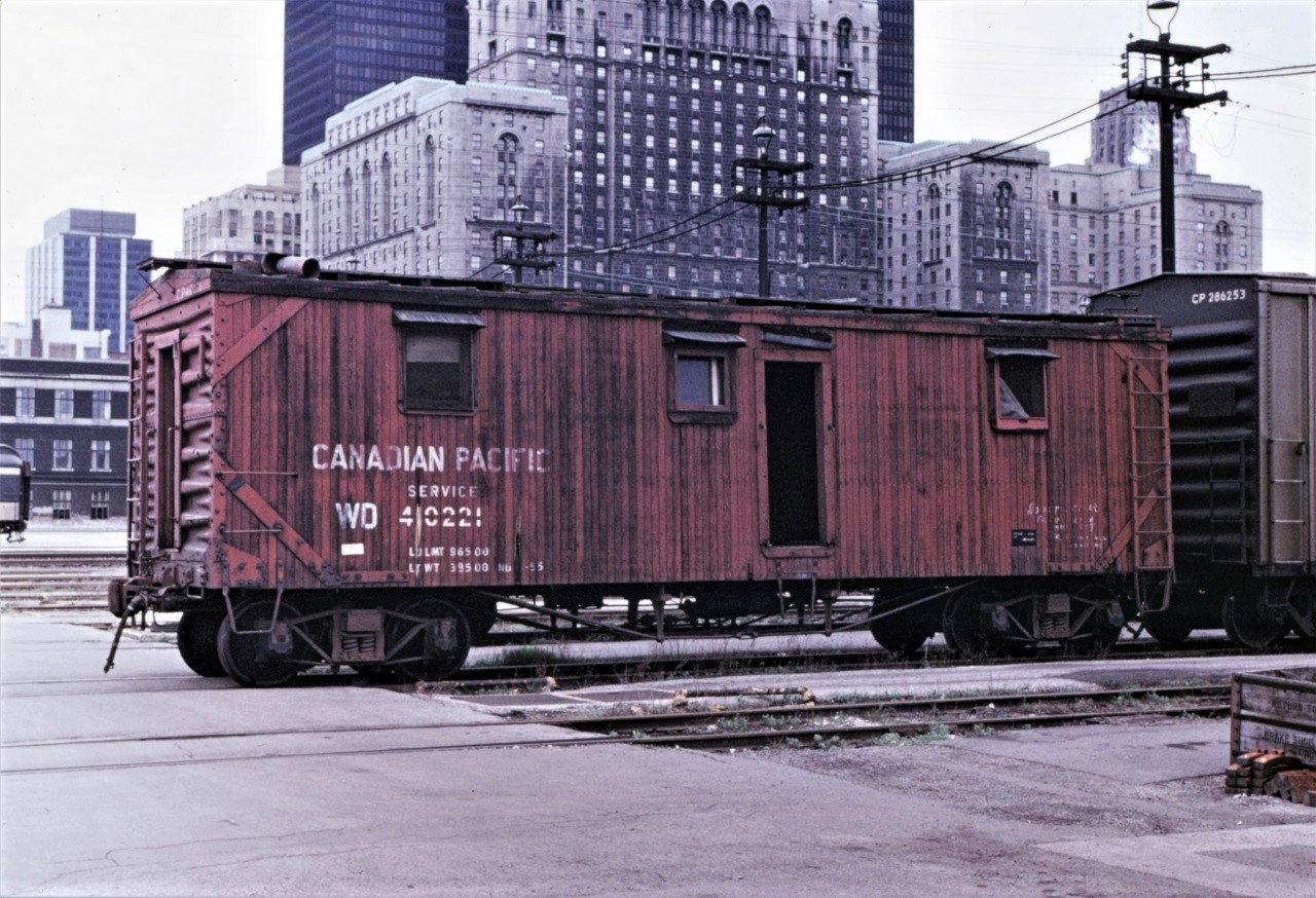 CP 410221 waits its end (notice the line painted through the number, bad order tag, and "WD" beside number) in CP's John Street coach yard in August 1970.  The car appears to have been extensively rebuilt in 1955 with steel ends but kept its arch bar trucks, KC brakes, and truss rods.  The Royal York Hotel is still several years away from its long overdue power washing.