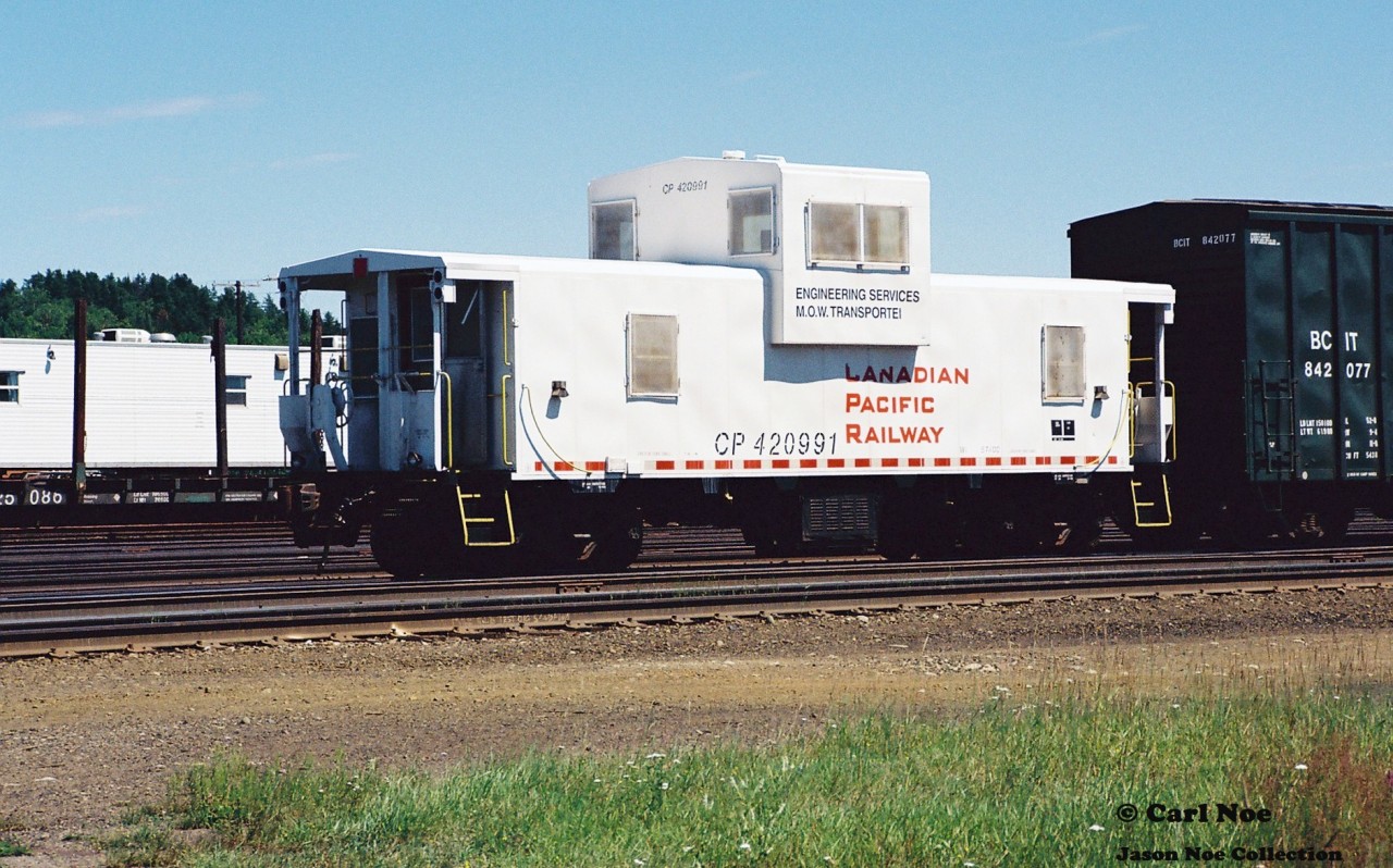 CP Engineering Services caboose 420991 is seen at Cartier, Ontario in the CP yard during the summer of 2000.