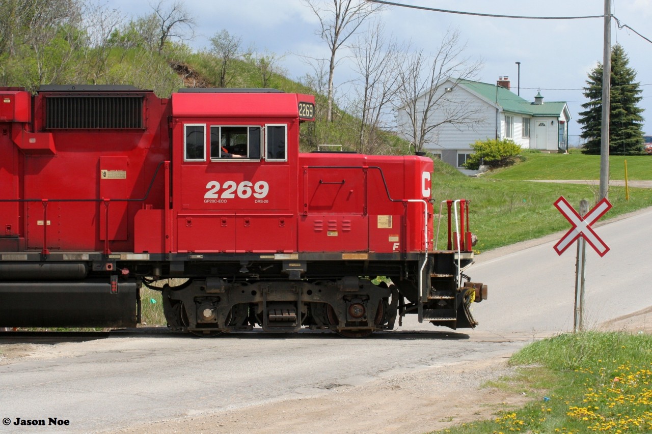 CP T78 is seen shoving to set-off four hoppers at the FS Partners facility switching over Greenfield Road in Ayr, Ontario on the Ayr Pit Spur with 2269 and 2259.