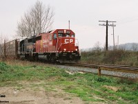 CP GP40-2 4656 and an ugly brother are viewed heading eastbound through the town of Ayr on the Galt Subdivision during an overcast fall day. This was likely either the London Pick-Up (T69) or the Hamilton Turn. 
