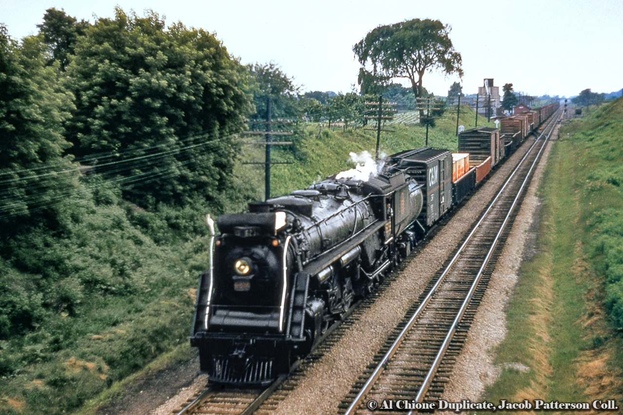 CNR 6232 descends the grade at Copetown with an eastbound freight about to duck under Highway 52.  Note the Chicago & Illinois Midland boxcar first up.  Built 1943, 6232 will be scrapped in 1961.Original Photographer Unknown, Al Chione Duplicate, Jacob Patterson Collection Slide.
