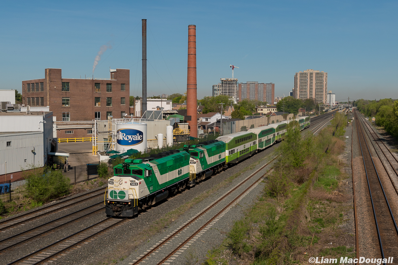 On a beautiful May morning, GO 563 & 557 highball out of Weston Station running around 30 minutes late as they pass the Royale/Irving Tissue factory on their way to Union Station. To the left of the engines you can see a former spur into the aforementioned factory, I wonder when it was last served by rail?
