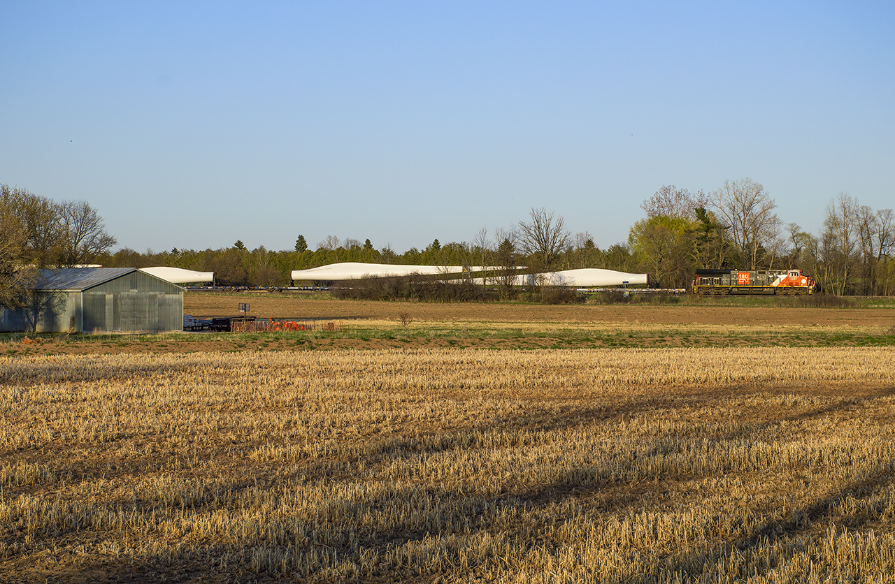 CN X319 cruises into the setting sun at Stewarttown headed for the BNSF at Chicago.