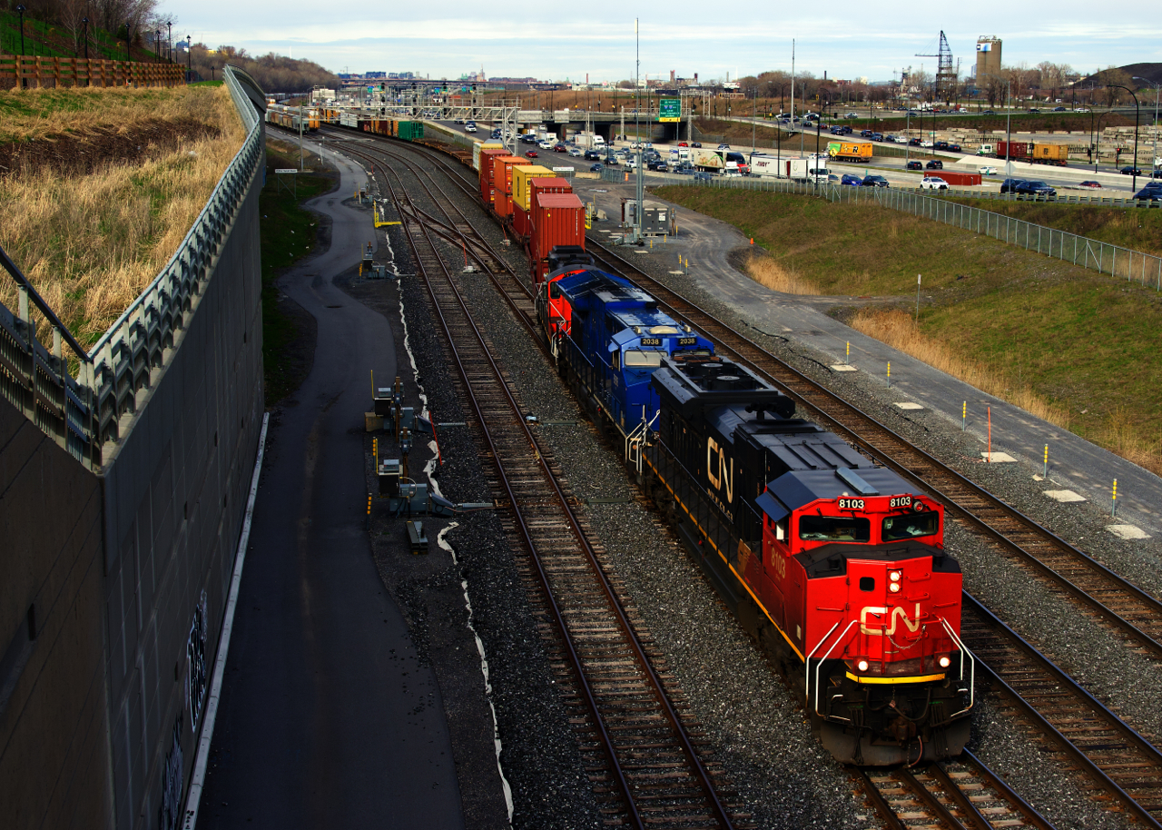A short CN 401 is crossing over from the South Track to the North Track to the Freight Track at Turcot Ouest. Power is ex-demo CN 8103, GECX 2038 & GP9 CN 4115.