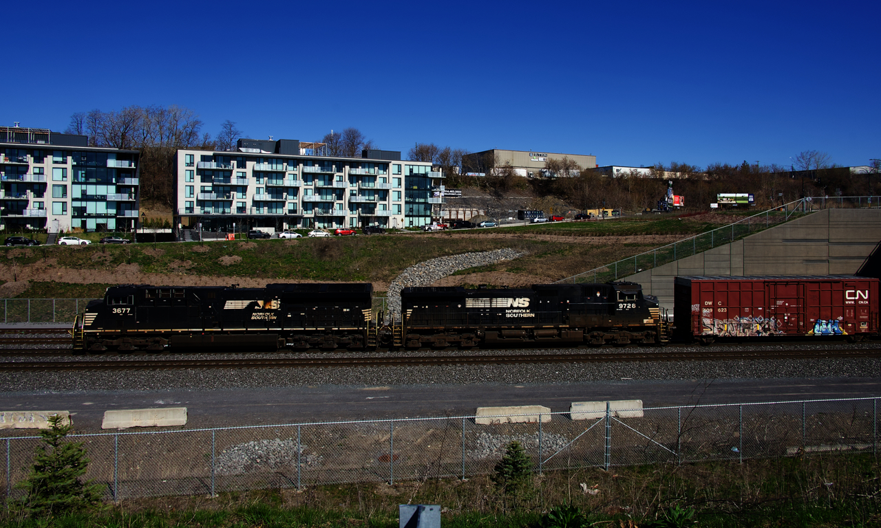 NS 3677 & NS 9728 sport two variations of the NS paint scheme as they head towards Taschereau Yard with a 59-car CN 529.