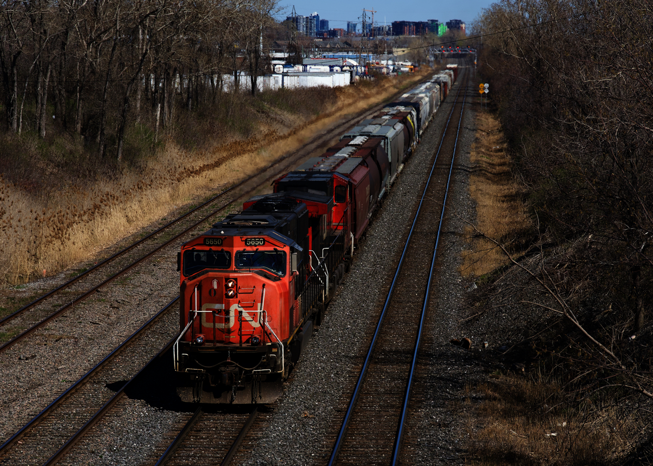 CN 527 is approaching Taschereau Yard with an SD75I and a Dash9 for power.