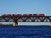 CP 229 (formerly CP 253) has a pair of EMDs bracketing a pair of GEVOs (CP 7054, CP 8916, CP 9355 & KCS 4163) as it crosses the St. Lawrence River. Behind the mixed freight is an entire empty ethanol train (CP 529).