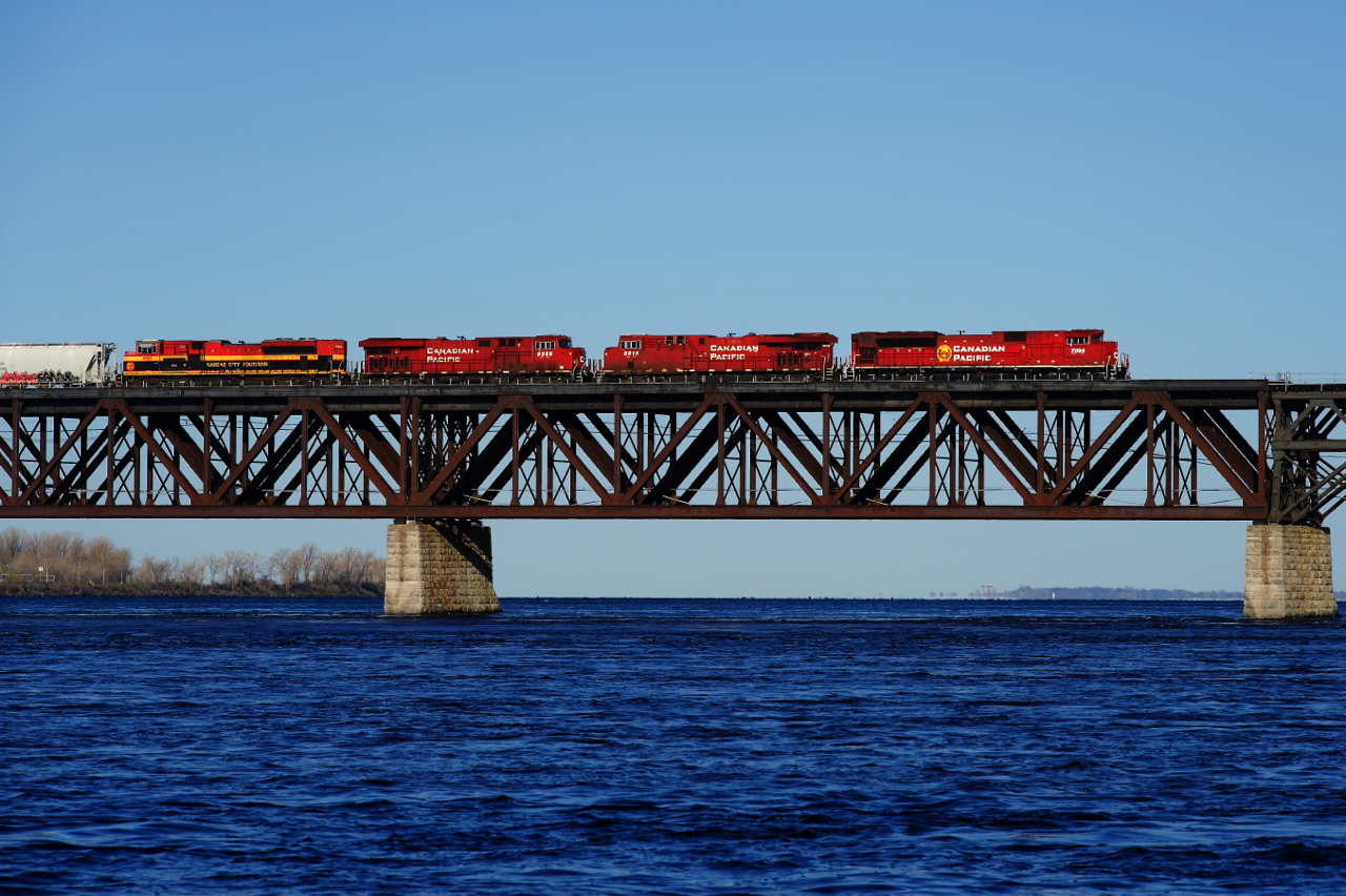 CP 229 (formerly CP 253) has a pair of EMDs bracketing a pair of GEVOs (CP 7054, CP 8916, CP 9355 & KCS 4163) as it crosses the St. Lawrence River. Behind the mixed freight is an entire empty ethanol train (CP 529).