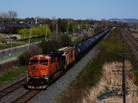 ES44C4 BNSF 6679 brings up the rear of ethanol train CP 528 (formerly CP 650) as it heads east on a warm spring afternoon.