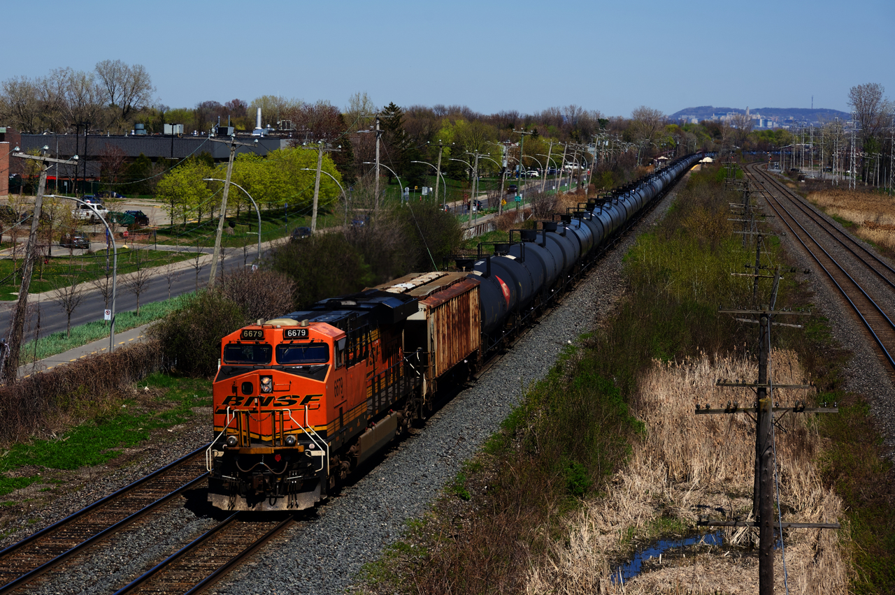 ES44C4 BNSF 6679 brings up the rear of ethanol train CP 528 (formerly CP 650) as it heads east on a warm spring afternoon.
