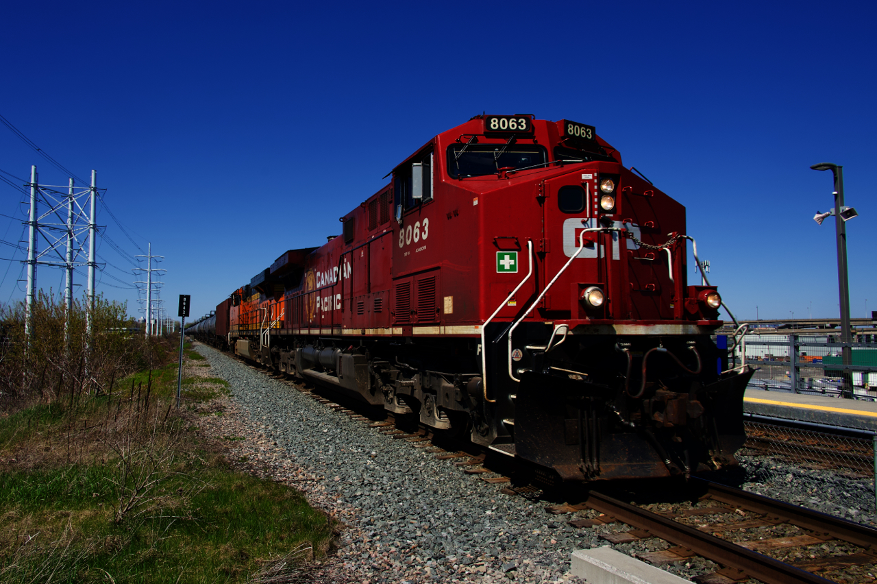 After a quick crew change, CP 528 is southbound and passing the Du Canal Station with CP 8063 & BNSF 6399 up front.