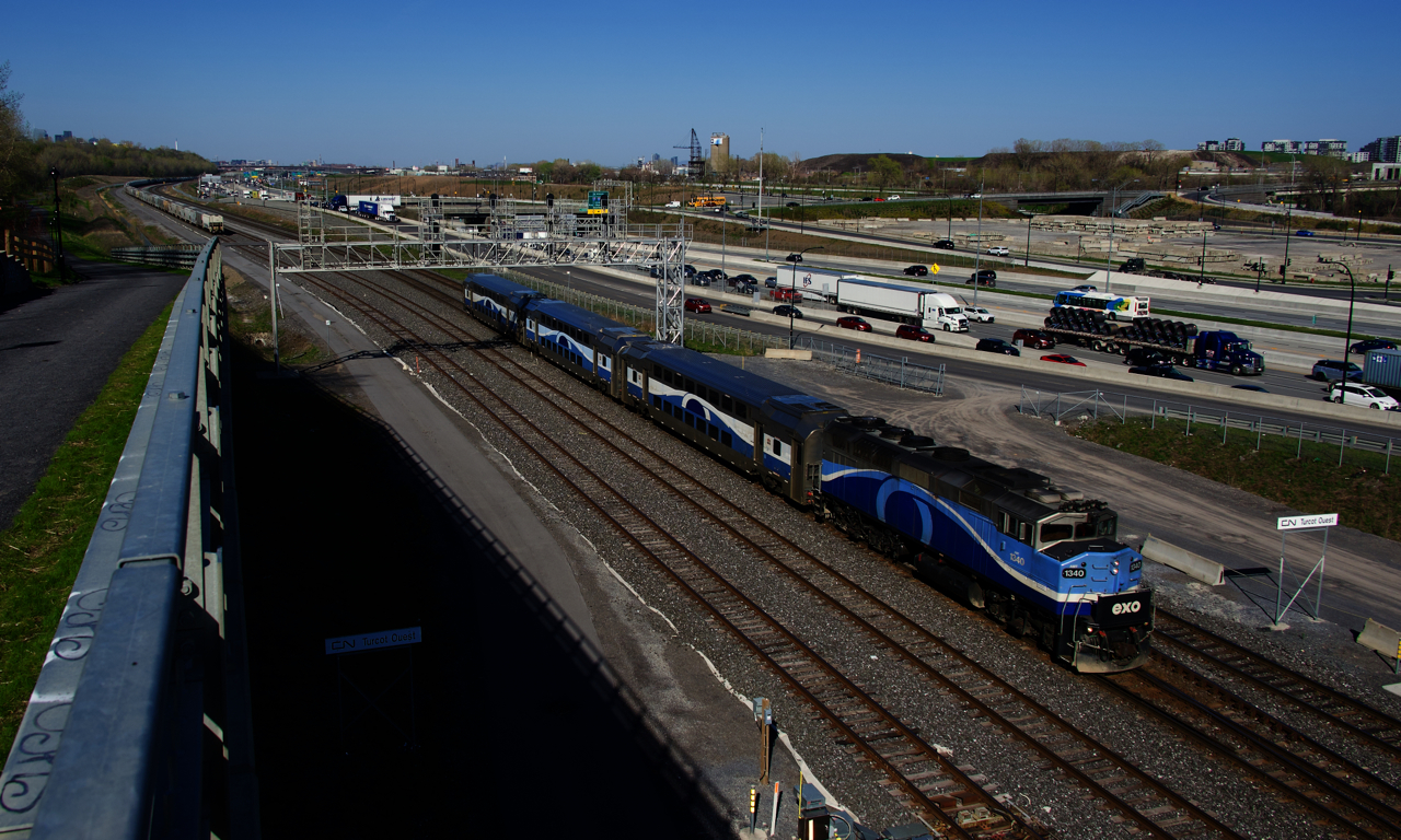 EXO 1209 is passing Turcot Ouest with AMT 1340 and three multilevel cars. At left is a new path which follows CN's Montreal Sub.