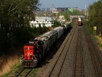 CN 596 with CN 7060 and CN 9523 for power is heading towards Taschereau Yard on the Transfer Track. This track rarely sees through moves like this, as it is used to store cars most of the time. At right in the distance is the tail end of CN 400, which is lifting cars at Turcot Ouest.