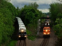 Both EXO 185 and CP 223 are heading in the same direction as the commuter train drops down the North Jct Lead and CP 223 passes on the Adirondack Sub. The <i>Every Child Matters</i> unit (CP 8757) leads CP 223 and is missing one numberboard after tangling with a downed tree earlier in the day. EXO 185 has a bilevel consist; EXO only has 22 bilevel cars, versus 160 multilevel cars.