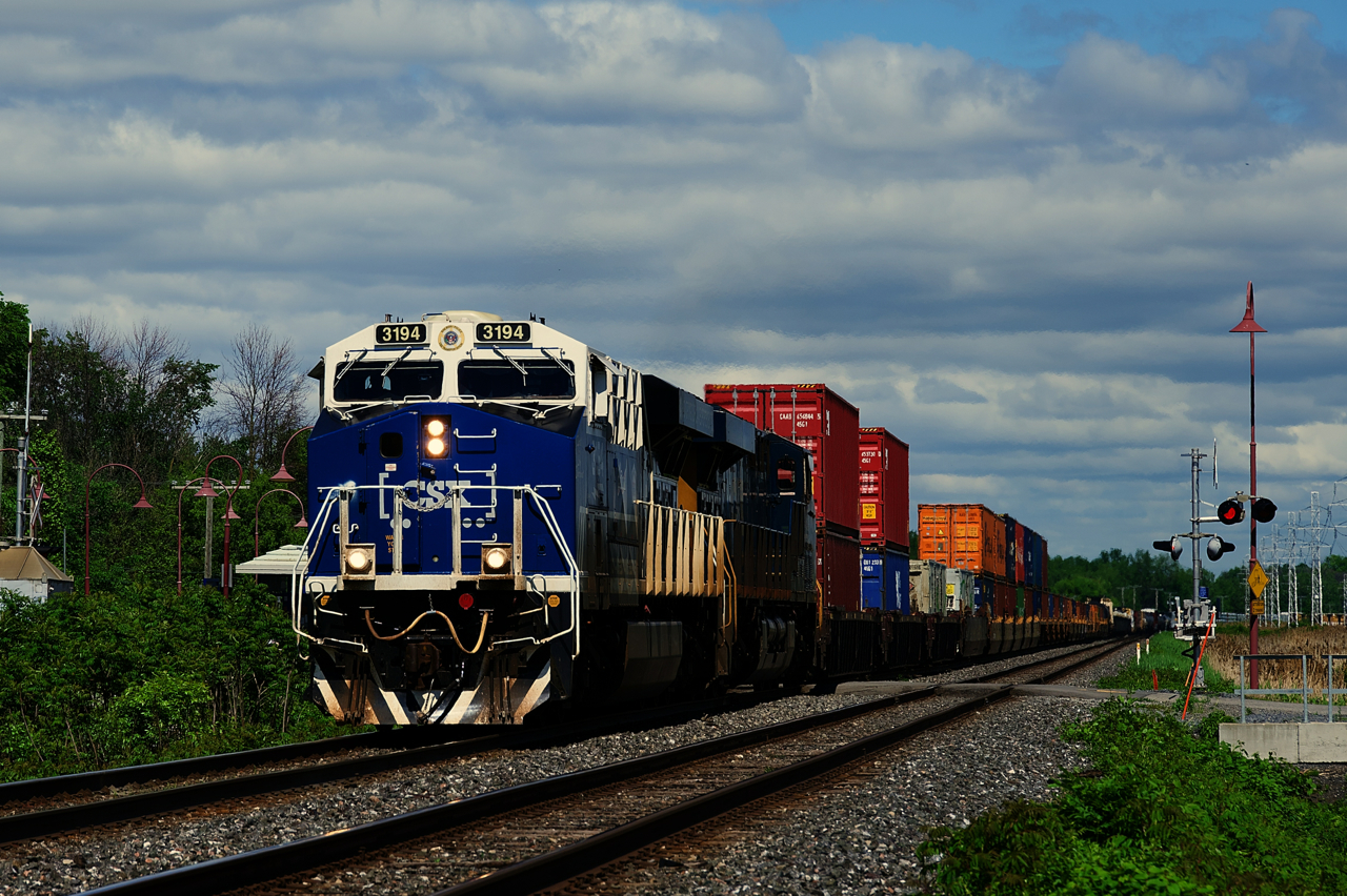 An eagerly but nervously anticipated CN 327 (will CSXT 3194 trail or lead after leading CN 326 into Montreal?) is approaching CN Caron where it will cross from the North to the South Track with a 127-car train (25 cars will be set off at Coteau). I believe this is the first time CSXT 3194 has been to Canada, at least in this paint scheme.
