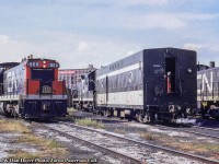 First generation passenger power sits on the shop tracks at Spadina, including two GMD-1s, one of which is equipped with snow shields beneath the handrails, a GP9, and an S7 for work around the terminal.  The Steele-Briggs Seed Co. building can be seen in the background at the corner of Spadina Ave. and Front St. The company specialized in seeds for the Canadian climate and growing season, and shipped many of it's seeds out by rail, the sidings located on the south side of the building, lasting until removal from the parking lot in late 2015.  Further information per <a href=https://tayloronhistory.com/2014/07/27/the-steele-briggs-warehouse-at-49-spadina-ave-toronto/>Toronto Historian, Doug Taylor.</a><br><br><i>Dan or Don Dover Photo, Jacob Patterson Collection Slide. Dan and Don were father and son railfans (publishers of Extra 2200 South magazine) whose photos have been amalgamated as the Dover Collection.</i>