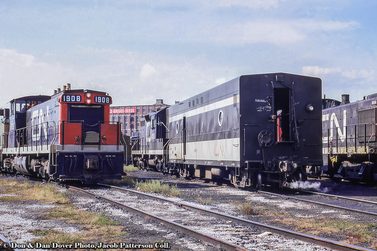 First generation passenger power sits on the shop tracks at Spadina, including two GMD-1s, one of which is equipped with snow shields beneath the handrails, a GP9, and an S7 for work around the terminal.  The Steele-Briggs Seed Co. building can be seen in the background at the corner of Spadina Ave. and Front St. The company specialized in seeds for the Canadian climate and growing season, and shipped many of it's seeds out by rail, the sidings located on the south side of the building, lasting until removal from the parking lot in late 2015.  Further information per Toronto Historian, Doug Taylor.Dan or Don Dover Photo, Jacob Patterson Collection Slide. Dan and Don were father and son railfans (publishers of Extra 2200 South magazine) whose photos have been amalgamated as the Dover Collection.