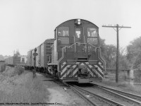 <b>The Last Mixed, Part 2.</b> On Saturday, August 4, 1962, four railfans from the Upper Canada Railway Society, including Basil Headford, boarded Canadian Pacific Mixed train M741 at Guelph headed northwest to Goderich on what was the final run of southern Ontario’s last CPR mixed train.<br><br>On the Goderich Sub, through Passenger service from Hamilton to Goderich (daily except Sunday trains 637/640 per 1954 timetable) ended in 1955, with service south of Guelph Junction to Hamilton cancelled.  During the 1930’s, this run was usually held by gas electric 9007 and a trailer <a href= https://scontent-yyz1-1.xx.fbcdn.net/v/t39.30808-6/274875428_7099366976804433_6343072801739430102_n.jpg?_nc_cat=110&ccb=1-7&_nc_sid=730e14&_nc_ohc=1RVW3tlnq4EAX9NOcML&_nc_ht=scontent-yyz1-1.xx&oh=00_AT99vsBkUwM9xpk9nfL_vhP6mYOeDko1SDR0gTt42aEAuA&oe=62902289>as seen in this March 1939 image at Guelph.</a>  Guelph Junction – Guelph Service remained <a href= http://www.railpictures.ca/?attachment_id=46944>typically using gas electric 9004</a> until April 26, 1958, when service was cut from six round trips per day to two round trips, and the doodlebug would be swapped for a mikado and combine.  Months later in fall 1958, this too would be replaced by a mixed train, which in turn would be cut in the fall of 1960, leaving just the mixed north of Guelph.<br><br>Here, CPR 8144 arrives back at Guelph with the last M742.  The siding switch has been lined for the station platform and once the train is spotted at the station, CPR mixed train service in southern Ontario will be history.  At right the Norwich Street bridge crosses the Speed River, and a portion of the Dunn Seeds plant can be seen on Cardigan Street.  <br><br>An article detailing the trip appeared in the September 1962 UCRS newsletter: <a href= https://drive.google.com/file/d/19w4ofWgh8vTBotAPpeuT6KQeAVDSGr74/view>found here.</a><br><br>CPR 8144, built by GMD in 1959, rebuilt to CP 1239 in 1981, retired 2012, sold to Independent Diesel Services of Minnesota.<br><br><a href= http://www.railpictures.ca/?attachment_id=47665>Part One: Setoff at Millbank</a><br><br><i>Basil Headford Photo, Jacob Patterson Collection.</i>