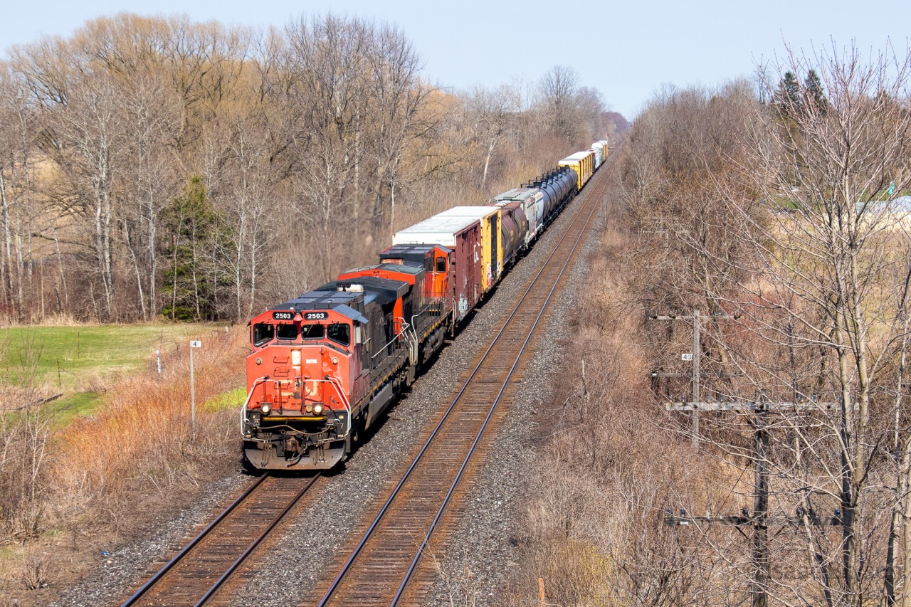 CN 435 races through the southern Ontario countryside with CN 2503, CN 2642, and a tiny train headed for London. With most of the Dash 8s in storage, the Canadian Cab Dash 9s are next up on the "must catch" list so it was nice to grab one in sunlight. Also of note are the 2 cylindrical grain hoppers buried in the train.