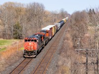 CN 435 races through the southern Ontario countryside with CN 2503, CN 2642, and a tiny train headed for London. With most of the Dash 8s in storage, the Canadian Cab Dash 9s are next up on the "must catch" list so it was nice to grab one in sunlight. Also of note are the 2 cylindrical grain hoppers buried in the train. 