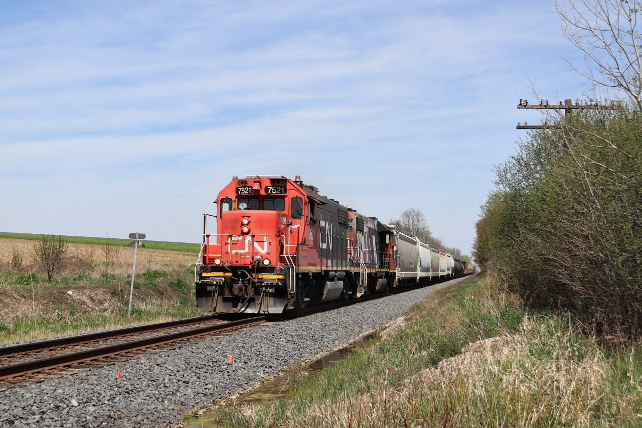 I was returning home and went by the Guelph version of Guelph Junction and found CN 540 working near Alma Street so I decided to try and make it to this location before its departure from there. Turns out I had plenty of time to beat it. The pair of GP38-2's in CN 7521 with CN 4726 rumble up to Wellington Road 32 on their way to Kitchener.