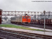 <b>Last CN Passenger service at Palmerston, part 2.</b>  Operating as extra 6354, formerly running as train number 668 -  the southbound RDC-3 from Southampton - coasts into Palmerston on Saturday, October 24, 1970 for the final time. Arriving at 0705h, the Railiner will be moved from the Fergus Sub side of the station over to the Newton Sub side to join the RDC from Extra 672 from Owen Sound <a href=http://www.railpictures.ca/?attachment_id=45100>which had arrived ten minutes earlier at 0655 (seen here).</a>  Both will be combined and having met extra 6118 (RDC-1), the former train 662 from Kincardine, will depart at 0715h for the trip to Toronto (formerly train 658) via the Fergus, Guelph, Halton, and Weston Subs. Extra 6118, which had arrived at 0700h from Kincardine, will too depart at 0715h for Stratford.<br><br>I believe the official last runs of the RDC service to Owen Sound, Kincardine, Southampton, and Goderich was the evening of Fri Oct 23, 1970. Although the Sat runs to Toronto (and Stratford) carried passengers, they were no longer operating as scheduled trains, hence the extra flags. Daylight Saving time ended early Sunday morning, Oct 25, 1979, and CN and CP would bring out their winter timetables at this time change.<br><br><i>John Freyseng Photo, David Warne Collection slide.</i>