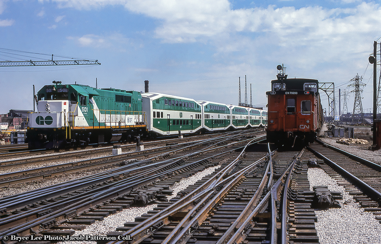 Saturday, April 29, 1978 saw GO Transit expand their operations north up the CN Bala Subdivision to Richmond Hill.  With F40 510 on the point and GP40TC 501 on the tail (presumed trailing since headlight is off), GO's inaugural trip is seen departing Union Station at Jarvis Street, passing the Crombie Park apartments public housing, under construction on the east side of Jarvis Street.  The train is made up of the new bilevel cars from Hawker Siddeley Canada, the first ones having been unveiled only five months earlier in December 1977.  With stops at all stations between Union and Richmond Hill, an opening ceremony took place at each stop, ending with a meet between the new GO consist and CNR 6060 and CN coaches at Richmond Hill to contrast the old with the new.  See shots of that event in the Doug Page shots below.  At right, a CN freight heads eastbound just clearing the junction with the high line Union Station bypass.Originally GO 601, and later GO 9801, GP40TC 501 would depart the GO roster in 1988 after 22 years of service, going to to Amtrak as 193, and later rebuilt in 2005 as Amtrak GP38H-3 521.More shots from the day:
6060 and GO 510 at Richmond Hill, by Doug Page
ONR TEE-equipped Northlander passing 6060 amongst the crowds, by Doug PageMore Jarvis Street action:Inbound GO F40 meets freight by Arnold Mooney, 1977Eastbound freight by Peter Jobe, 1980VIA Turbo by Bruce Acheson, 1981Bryce Lee Photo, Jacob Patterson Collection slide.