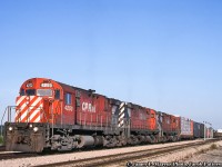 Waiting to depart stateside, a trio of MLW C424s sit on the head of a freight at Welland Yard.  Of these three units, only 4223 would continue her career, initially on the QGRY, then through various brief owners until arriving at the Western New York & Pennsylvania as their 434.  Recent photos from 2019 <a href=http://www.rrpicturearchives.net/showPicture.aspx?id=5324625>show it appearing to be a parts unit.</a><br><br><i>James P. Marcus Photo, Jacob Patterson Collection Slide.</i>