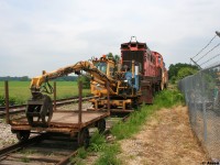 Ontario Southland Railway (OSRX) 506 and OSRX L3 along with a former CP Rail baggage car and some track equipment are viewed during a summer afternoon in the sleepy village of Mount Elgin on the former CP Port Burwell Subdivision. 
