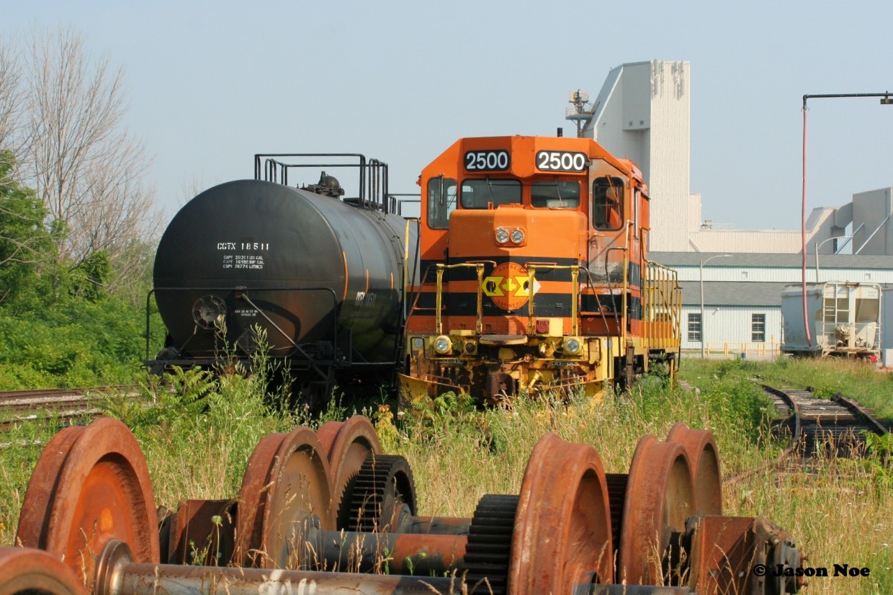 In March 1998, Quebec-Gatineau Railway (QGRY) GP35 2500 was released fully repainted in G&W’s orange colors. Previously to that, the unit originally was built by EMD for Southern Pacific during 1965 and was numbered 7724. More than 56 years after emerging from the EMD facility in Illinois, QGRY 2500 is viewed during a summer evening in Goderich beside Goderich-Exeter Railway’s shop having only completed one revenue trip in the past couple years due to various mechanical ailments.