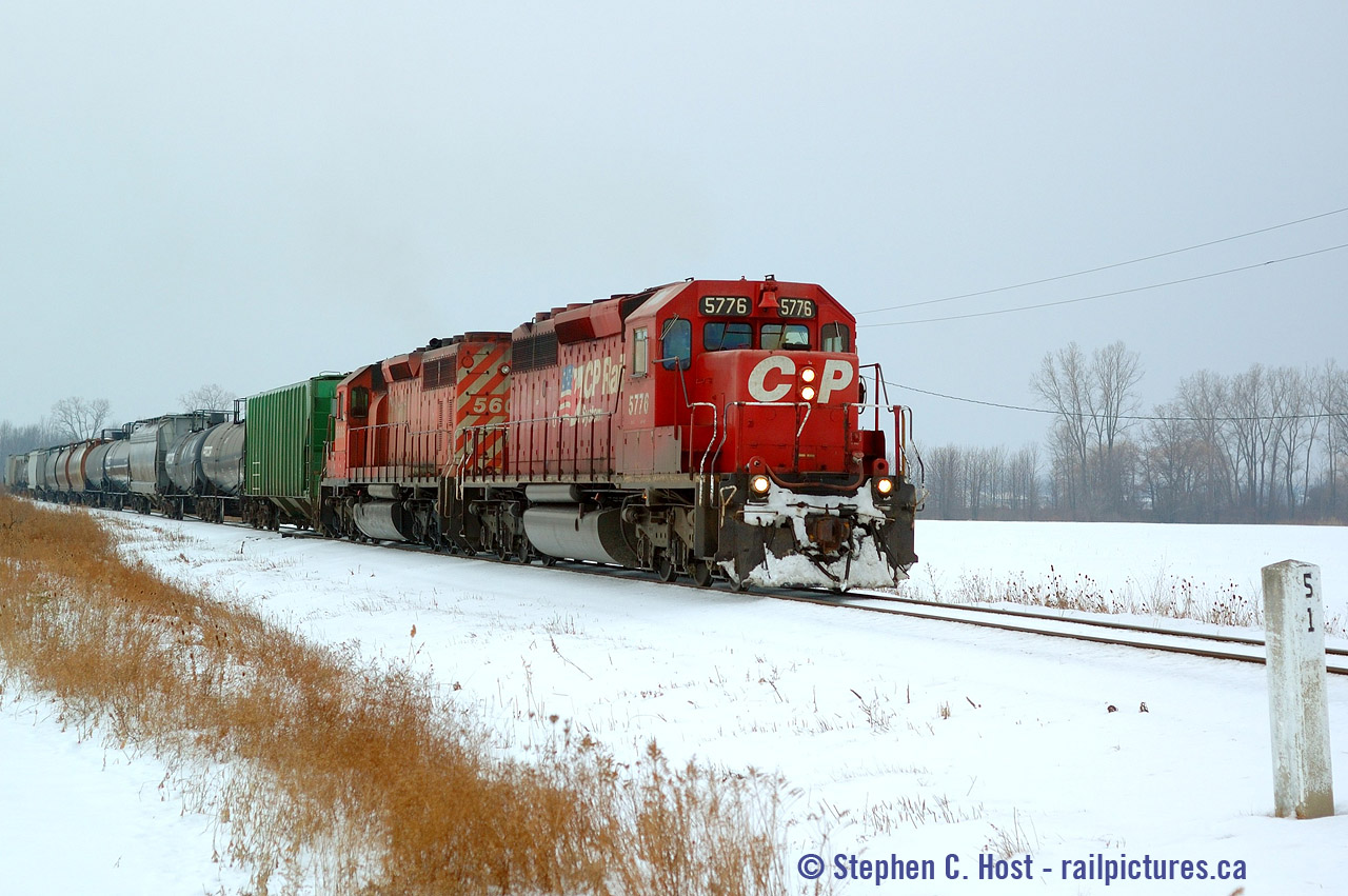 It's 2 PM and I left Sarnia in the afternoon to see if I could find the northbound freight from Chatham. I found them around Sombra, but my chase was very brief as it only lasted two crossings. Pictured they are passing one of the many concrete mileposts (and whistleposts) that still dot the landscape on the Sarnia sub all the way to Blenheim. Due to the crew being out of hours, they'll park at the next crossing, get into a waiting crew vehicle and be sent back to Sarnia. While I took this D724 with a single unit had gone into the clear at Methes Energies (Sombra customer) and were dropped off to relieve the D725 crew, and would be on the move not long after swapping crews in Sombra.