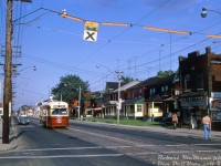 TTC PCC 4364 (A6-class built CC&F 1947-48) trundles westbound along Dundas Street West through <a href=http://www.railpictures.ca/?attachment_id=35760><b>the Junction</b></a> neighbourhood, approaching Gilmour Avenue while passing rows of old houses and storefronts lining the south side. The streetcar is on the final approach to nearby <a href=http://www.railpictures.ca/?attachment_id=36016><b>Runnymede Loop</b></a>, the westernmost terminus of the line.<br><br>This branch of the Dundas streetcar (that continued from Dundas West subway station through the Junction to Runnymede loop) was discontinued and replaced with the new 40 Junction trolleybus route when the Bloor-Danforth subway line extensions opened in May 1968. Today it is operated by diesel buses, and much of this stretch of Dundas appears very much the same as it did then.<br><br><i>Robert McMann photo, Dan Dell'Unto collection slide.</i>