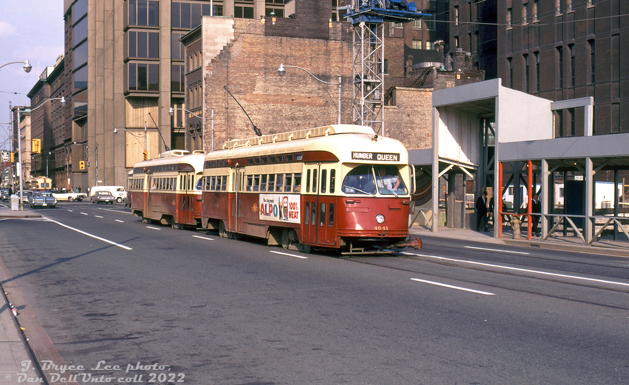 TTC PCC 4641 (an A11-class ex-Cleveland car) heads westbound on Queen Street West past Bay Street with a 4400-series A7-class car trailing, operating in MU service on the busy Queen route. Two other cars can be seen together heading eastbound in the distance. MU couplers were maintained on the 4400- and 4600-series PCC's for multiple unit operation on the busy Bloor/Danforth and later Queen routes.

The streetcars are passing by ongoing construction on the new Four Seasons Sheraton Hotel (opened 1972, now Marriott's Sheraton Centre), which replaced a row of old stores along here that were demolished in late 1964 (among them, Henry's Camera was once located here at 63 and later 111 Queen Street W, before moving to Church when the strip of buildings were demolished in 1964). The old Toronto Dominion Bank building remains for now (replaced with a modern TD banking pavillion later on).

In the background is the new Simpson Tower (built 1968), build adjacent to the flagship Simpsons department store (in the distance) at Queen and Yonge, a popular stop for streetcar and subway patrons for decades. 

J. Bryce Lee photo, Dan Dell'Unto collection slide.