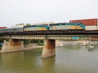 Less than 4 hours after arriving, VIA Rail has turned and serviced the equipment and train 693 begins its almost 2 day journey back to Churchill (about 3 hours late). Today's train is powered by F40PH-2D units 6457 and 6441, with baggage car 8601, coaches 8123, 8124, and 8104, Skyline 8506 and sleeper Chateau Marquette. (The train is crossing the Assiniboine River, immediately south of the station (timetable West)--photo taken from the Main Street bridge.(