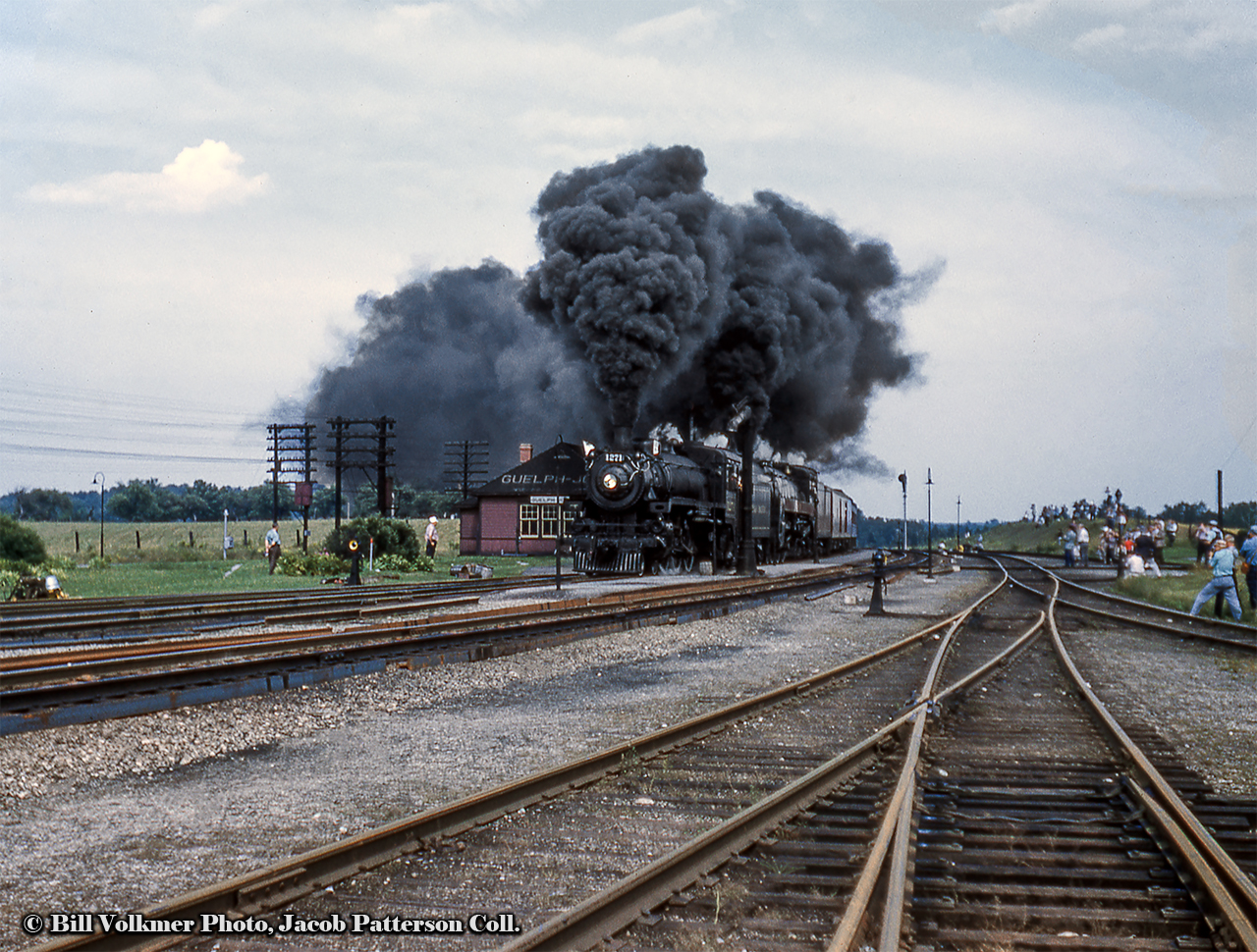 A double-headed excursion behind CPR G5c Pacific 1271 and H1c Royal Hudson 2839 storms past the station at Guelph Junction, cresting the grade beneath a billowing plume of smoke.  The annual NRHS Buffalo Convention was held in Toronto at the end of August 1958 featuring a two-day set of excursions, one over the CPR and one over the CNR the following day. The CPR excursion ran Toronto - Guelph Junction - Hamilton and return via Oakville. The other excursion can be seen at CNR Guelph Junction by clicking here.By this time only four steam locomotives (including the two pictured) were still active out of John Street, 1271 (last G5c Pacific, built by CLC April 1947), Royal Hudson 2839 (H1c, MLW 1937), 1265 (G5c, CLC 1947), and 2399 (G3g, CLC 1942), all but one of one of which would be retired and scrapped. The survivor, CPR 2839, is now on display at Sylmar California as part of the Nethercutt Collection. Thanks to Ray Kennedy and George Roth for information.Standing off to the right, Edward P. Haines snapped this shot, while another photographer captured the movement crossing over to the Oakville Subdivision at Hamilton Junction.Bill Volkmer Photo, Jacob Patterson Collection slide.
