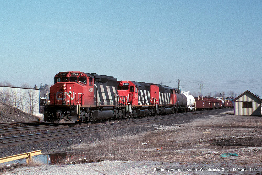CN 5247, CN 5049, and an unidentified SD50F/60F roll through Woodstock with a westbound freight on March 12th, 1995