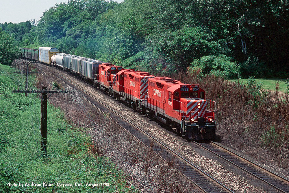 A trio of CP GP9u's (CP 8222, CP 8225, and CP 8205) executing running rights across CN's Oakville sub with an eastbound freight in August of 1992