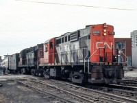 CN 3118 is leading an eastbound VIA train in London, Ontario in April 1982.