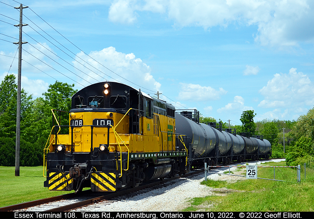 Essex Terminal GP9 #108 has the "A/C" on as it rounds the curve and approaches the Texas Road crossing just North East of the town of Amherstburg, Ontario.  With 5 tanks in tow, ETR #108 is certainly not exceeding the 25kmph limit shown on the barrier sign next to the tracks.  ;-)