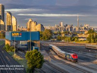 Welcome Back To Canada. For the first time since 2020, the Amtrak Maple Leaf (Train 63/VIA Train 98) returned to Toronto, Ontario on Monday, June 27, 2022. Due to a suspension related to the pandemic, service on the Maple Leaf had been operating between only between New York’s Penn Station and Niagara Falls, New York. For the occasion, Amtrak 108 (P42DC, 50th Anniversary, Phase VI) was selected to lead the first run. The train is seen at the end of the day with the CN Tower emerging from the Toronto, Ontario skyline, entering the VIA Toronto Maintenance Centre where it will spend the night before returning as Amtrak Train 64/VIA 97 the following morning.

More on Amtrak's Commemorative 50th Anniversary Locomotives: https://media.amtrak.com/2021/03/amtrak-releasing-six-50th-anniversary-commemorative-painted-locomotives/
