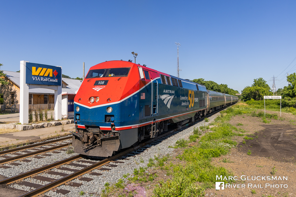 What Goes Up Must Come Down. With the prior day's run of the first Amtrak Maple Leaf (Train 63/VIA Rail Canada Train 98) returning to Toronto, Ontario for the first time since 2020, Amtrak 64/VIA Train 97 on Tuesday, June 28, 2022 was the first eastbound run. Amtrak 108 (P42DC, 50th Anniversary, Phase VI) was selected to lead the first full run to Toronto, which had been truncated between New York’s Penn Station and Niagara Falls, New York due to pandemic related service cuts. The train is seen passing through the Grimsby, Ontario VIA Station, a clear indication that it is not in the United States. 

More on the Maple Leaf return:
https://media.amtrak.com/2022/06/amtrak-maple-leaf-travelers-can-now-buy-tickets-to-and-from-toronto-with-service-set-to-resume/

More on Amtrak's Commemorative 50th Anniversary Locomotives: 
https://media.amtrak.com/2021/03/amtrak-releasing-six-50th-anniversary-commemorative-painted-locomotives/