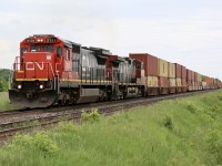 A shot I figured I’d never get again. A standard cab Dash-8 up front on a hot stack train. There was a time I would not go out of my way for a Dash-8 heading up a consist  but thanks to a friendly heads up this morning I figured I’d see how things would play out. It is sad to see one by one all of CN’s Dash -8’s sent to scrap, (a few have found new homes). Today the active fleet can be counted with two hands and there time is not long here on earth as CN recently has been scrapping most that have been retired. I wonder how many more trips 2131 has left in it, before it’s demise. Only time will tell. Nevertheless as the sun quickly vanished CN train 148 began to tackle the slight grade at Tansley, and the location of the new intermodal yard that will be complete in the next few years. Former UP/CNW 2131 is in the lead while one of CN’s Dash-9 from one of the last orders is trailing. Hopefully this will not be the last CN Dash-8’s I cross paths with. 