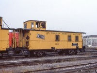 <b>”Hold tight till footing’s right”.</b>  One of TH&B’s safety slogans adorns the side of van 63 at Aberdeen Yard.  63 is now preserved by <a href=http://www.trainweb.org/oldtimetrains/photos/businesses/THB_63.jpg>Dowler-Karn fuels at Yarmouth</a> between the former CASO right of way, and Cayuga Sub.  Van 61 can be seen at left.