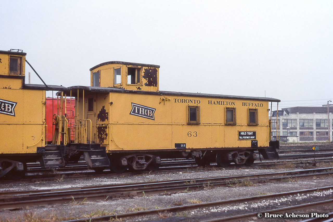 ”Hold tight till footing’s right”.  One of TH&B’s safety slogans adorns the side of van 63 at Aberdeen Yard.  63 is now preserved by Dowler-Karn fuels at Yarmouth between the former CASO right of way, and Cayuga Sub.  Van 61 can be seen at left.