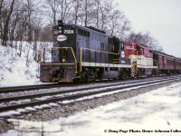 January 14, 1967 was a special day for fans of the Toronto Hamilton & Buffalo Railway, as the Upper Canada Railway Society ran an excursion covering TH&B and NYC lines (NYC owning 73% of the TH&B, CPR the other 27%) in Southern Ontario, and included utilizing an NYC GP9 on the point. Here, the train has finished the first leg of it’s trip from Hamilton – Waterford via Brantford.  Now on the CASO just east of the Main Street overpass, it will run east on the NYC to Welland, turning back west on the TH&B for the final leg, Welland - Hamilton.<br><br>More of this excursion<br><a href=http://www.railpictures.ca/?attachment_id=47055>Waiting to depart Hamilton,</a> Doug Page<br><a href=http://www.railpictures.ca/?attachment_id=47496>Climbing the grade at Summit,</a> Doug Page<br><a href=http://www.railpictures.ca/?attachment_id=24049>Another angle at Summit,</a> Bill Thomson<br><br><i>Doug Page Photo, Bruce Acheson Collection Slide.</i>