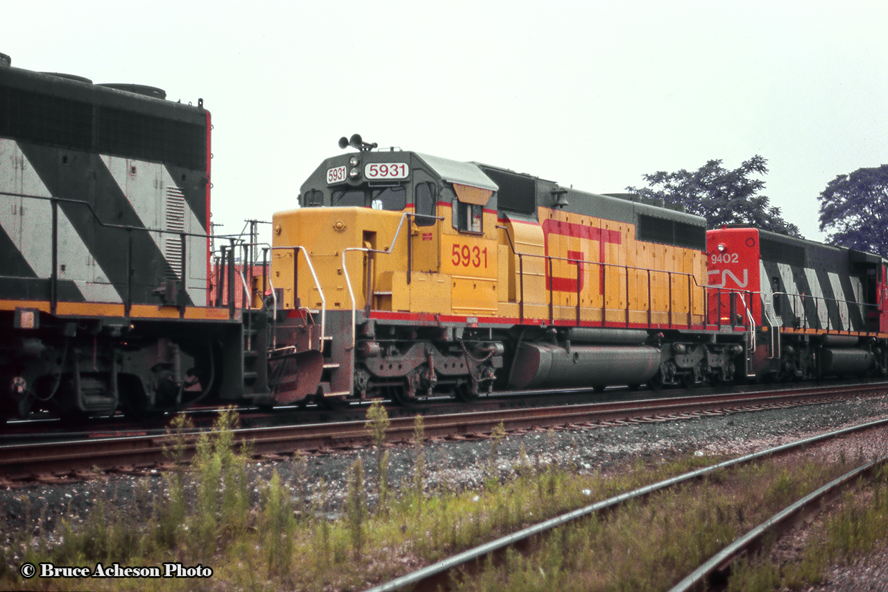 GT 5931, originally Missouri Pacific 3174, and later UP 4174, still wears it’s armour yellow paint from it’s previous owner as it trails through Bayview Junction.  Acquired shortly before this photo in 1990, the units (5930 – 5937) have since received GTW blue or CN paint, and are largely still active on the roster.