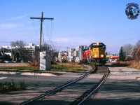 A dimensional movement of three transformers from ABB, two on flatcars, the third on schnabel car HEPX 200, crawl slowly through Guelph approaching Suffolk Street.  The site seen here used to have much more rail activity with the Guelph City Spur branching off towards the pine tree, customer <a href=https://s3.amazonaws.com/pastperfectonline/images/museum_51/156/201484616.jpg>Federal Wire & Cable Co, later Pirelli Cable</a> off to the right, and an interchange connection with the Guelph Radial Railway at right on Suffolk Street before it was removed in 1929.  The Pirelli site is now a housing development, their parking area at left is now a park, and the City Spur was <a href=https://drive.google.com/file/d/1jcWPFor3CSOpjpm_LbtLyV1VZRZKQhq-/view?usp=sharing>pulled up in 1972.</a>