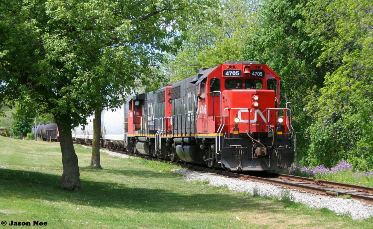 CN L540 with 4705 and 4796 slowly work their way down the Huron Park Spur in Kitchener after crossing Queen Street during a perfect spring day. L540 would set-off several cars at the interchange with Canadian Pacific before working Ampacet Canada at the end of the spur.