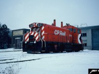 CP SW1200RS 8161 sits in front of the old Grand River Railway shop along King Street in the Cambridge suburb of Preston, Ontario during winter 1982. 